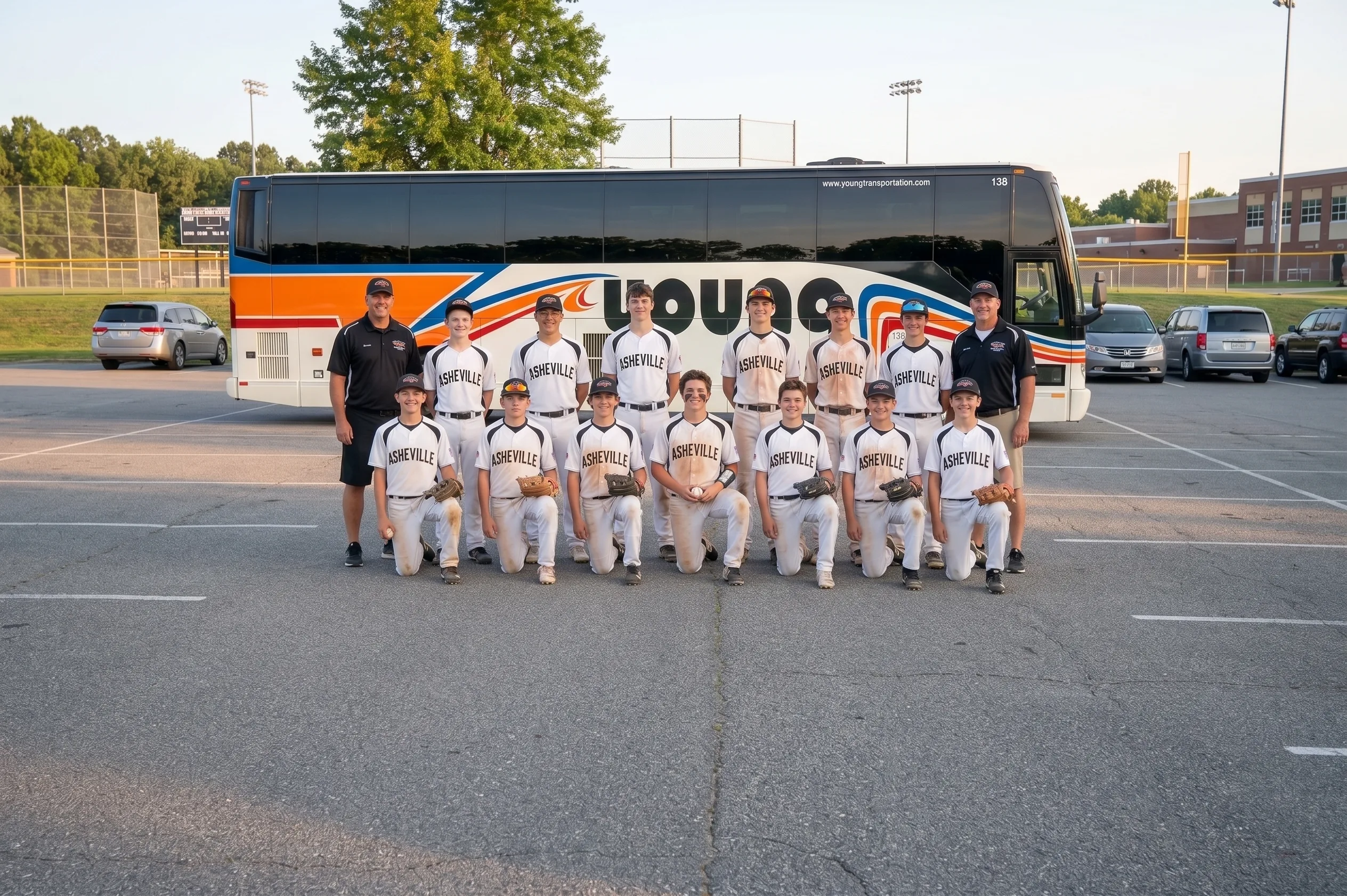 Asheville youth baseball team posing in front of a Young Transportation motorcoach for team travel